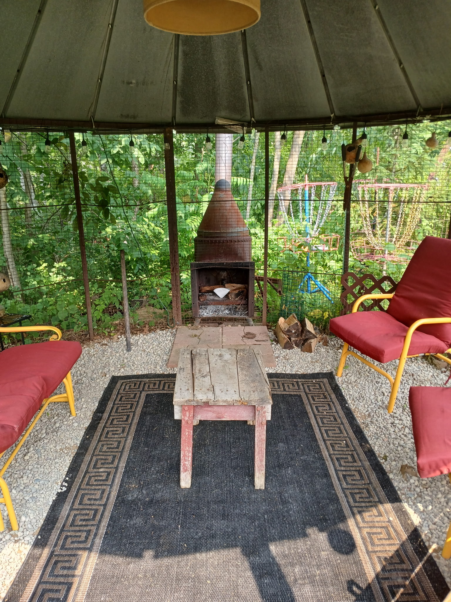 Inside the corn crib: a fire, rugs and chairs pulled up